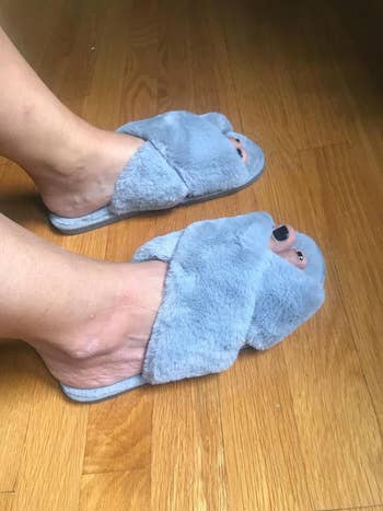 a reviewer in plush light blue slippers