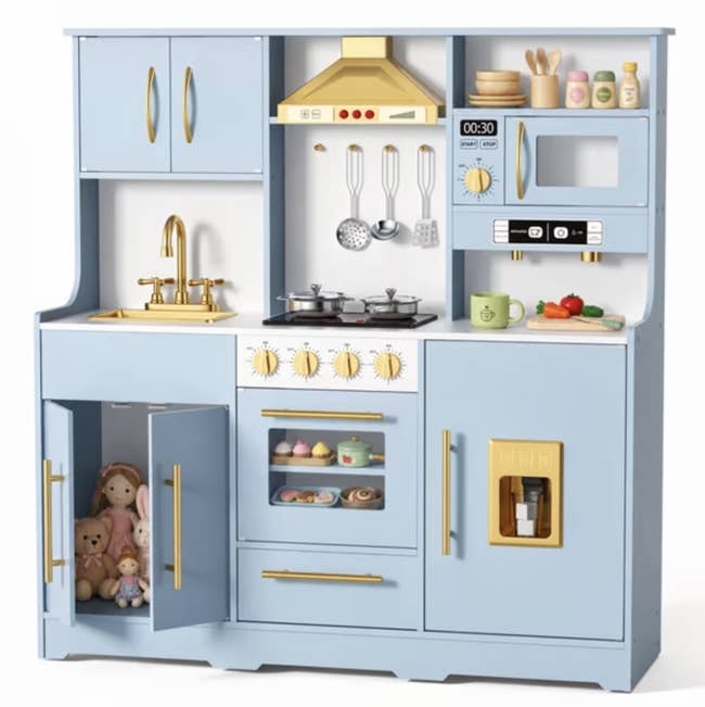Children's play room acceptable with artifact stove, oven, sink, and cabinets. Includes artifact food, utensils, and plush toys connected the shelves