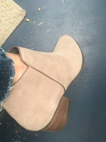 reviewer wearing the same boots in sand suede color