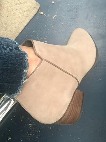 reviewer wearing the same boots in sand suede color