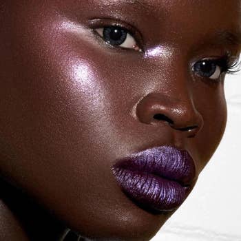model wearing purple pigment on their lips