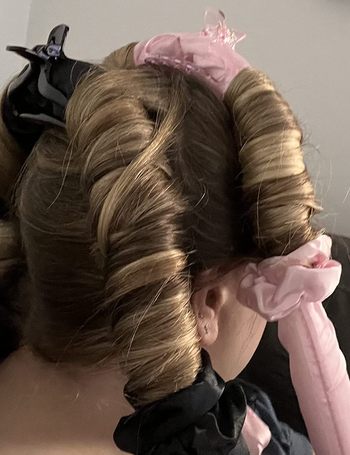 reviewer with headband curler in hair