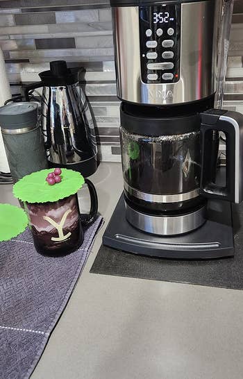 reviewer photo of coffee maker on the sliding tray in the closed position
