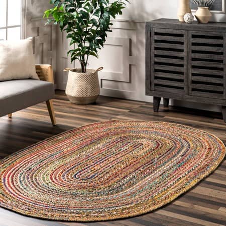 the oval shaped multi-colored jute rug in a living room