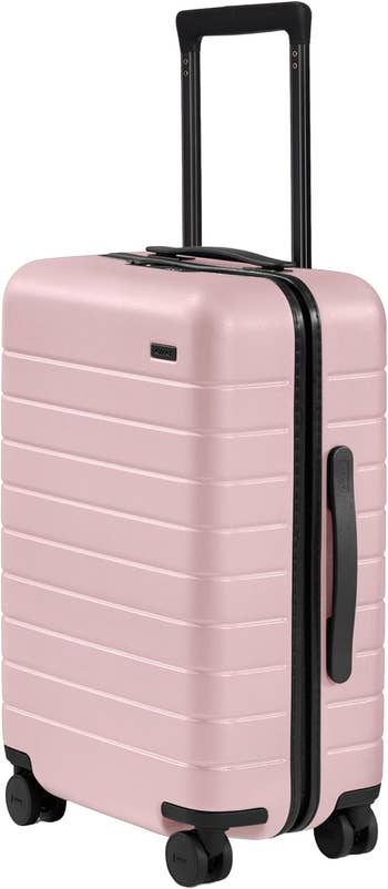 A modern, hard-shell suitcase with a retractable grip and spinner wheels, designed for convenient question and casual portability