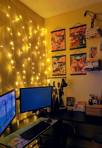 fairy light hung up behind reviewer's monitors