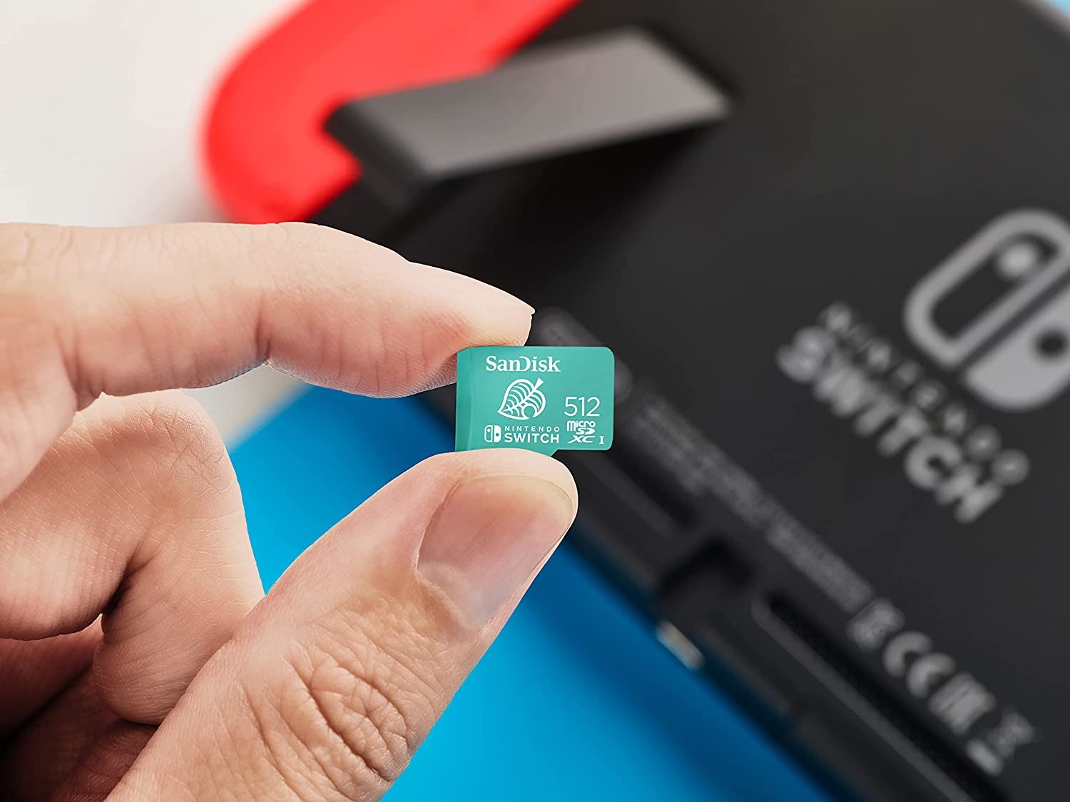 a hand holding the 512gb sandisk memory card