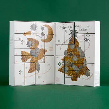Advent calendar with themed metallic  and golden  illustrations, showing numbered doors for each   time  featuring quality   products