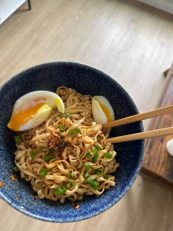 Reviewer's bowl of ramen with soft-boiled egg and chopsticks