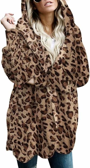 A model wearing the cardigan in a cheetah print