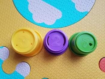 reviewer image of the yellow, purple, and green cups; each of which has a number on it