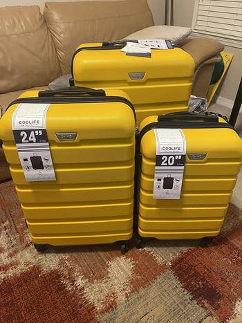 another reviewer shows a close up of their three yellow rolling suitcases