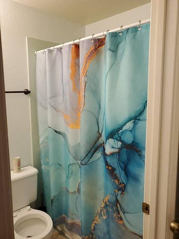 reviewer's colorful marble pattern shower curtain