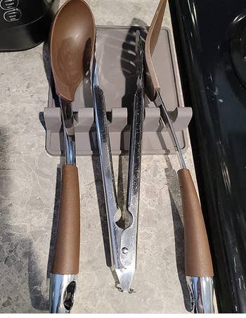 Gray XL version holding tongs and spatulas 