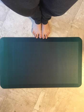 Reviewer standing in front of anti-fatigue mat
