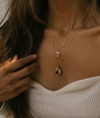 a model wearing the small and large locket sizes