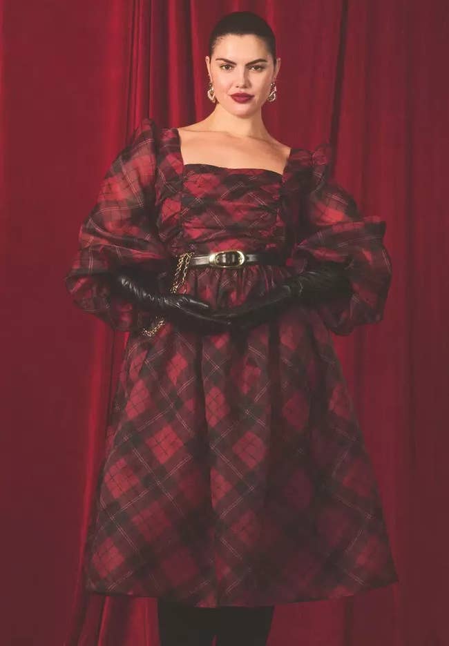 model posing in the red and black plaid dress