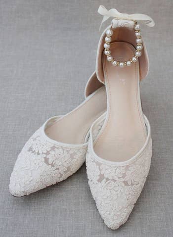 the white flats with pearl straps