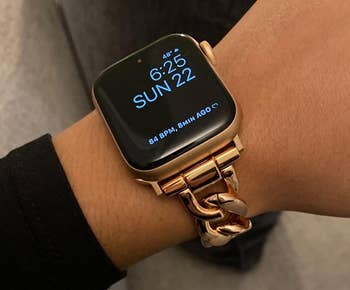 side view of a reviewer wearing the gold apple watch band