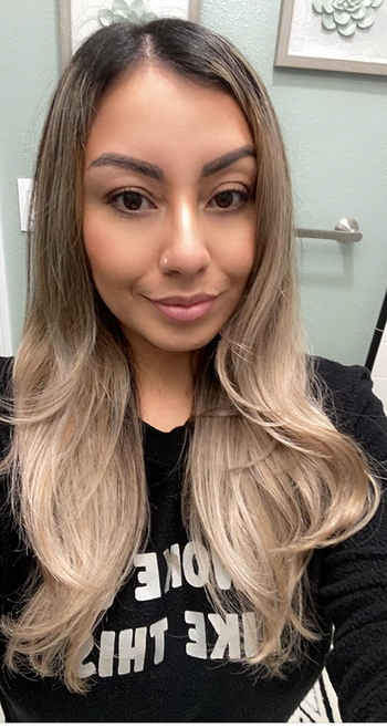 reviewer with blown out medium length hair slightly curled at the edges 