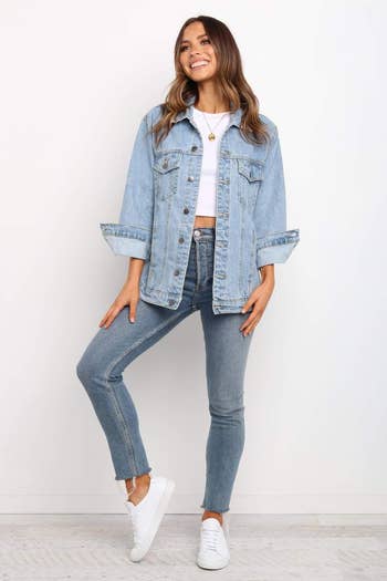 front view of a model in the light blue denim jacket