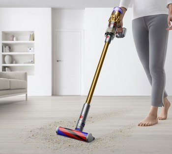 Model pushing Dyson Micro on hardwood floor