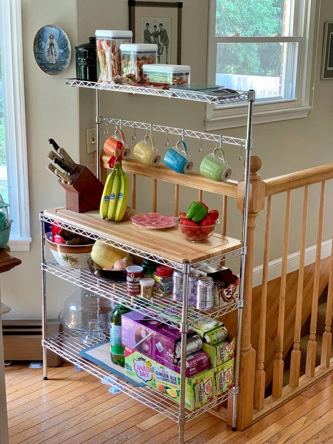 cutting board, bananas, knives, mugs, canned and boxed goods, snacks, and a pasta jar connected top