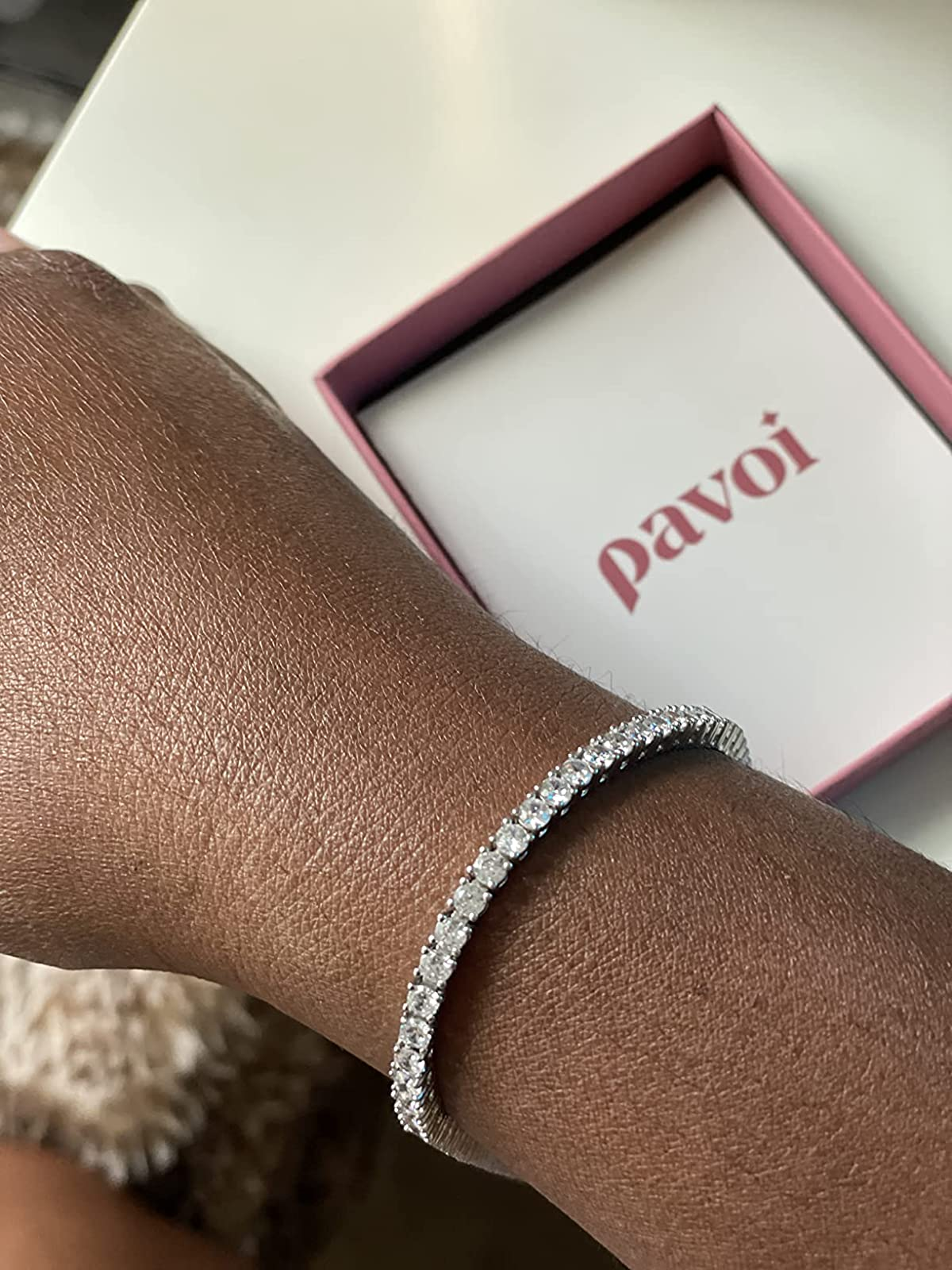 reviewer wearing the metallic  bracelet connected  their wrist