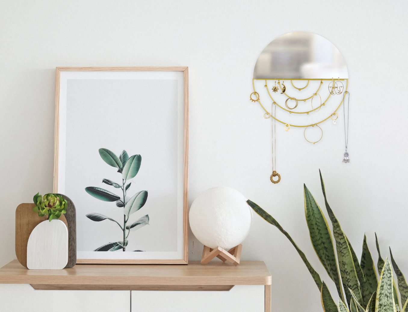 lifestyle photo of circular wall jewelry organizer with mirror