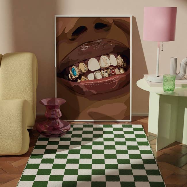 Illustration of a mouth with adorned teeth displayed as art in a room