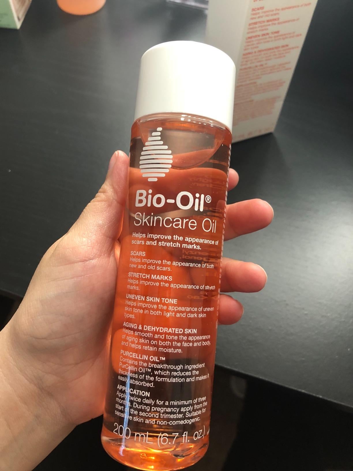 hand holding bottle of bio oil