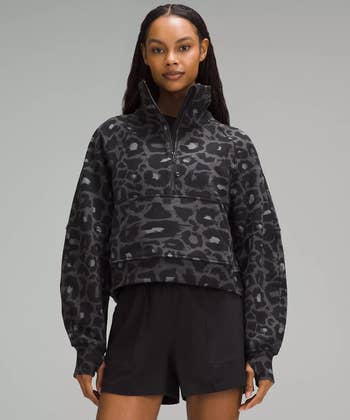 A model wearing a black leopard print sweater