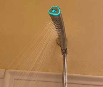 Reviewer's shower head running with temperature lit green at 105 degrees