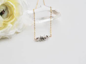 a herkimer diamond pendant necklace with a gold chain