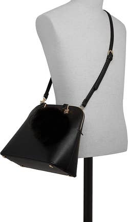 The bag on a mannequin showing it being used as a crossbody bag with straps