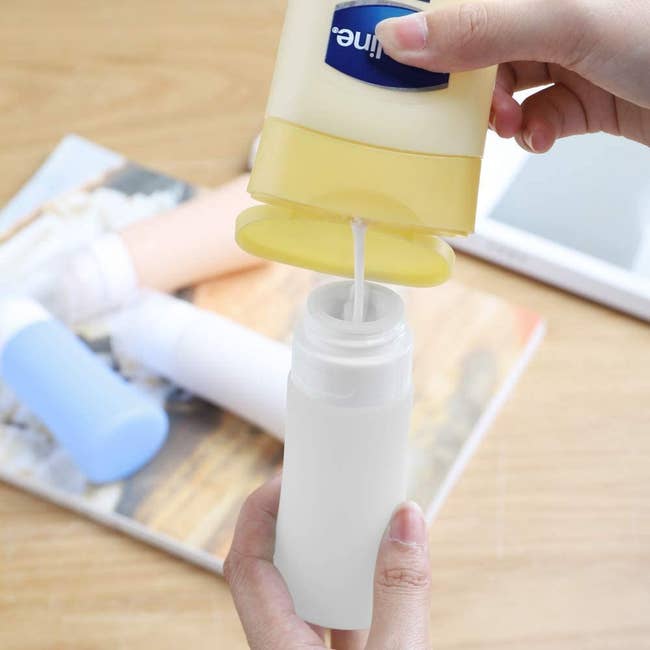 person pouring full size lotion into bottle