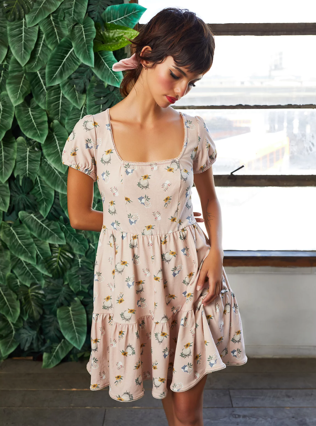 aa model in a pale pink t-shirt dress covered in a totoro design