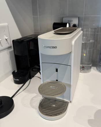 Nespresso java instrumentality connected a room antagonistic with a h2o vessel and solid nearby