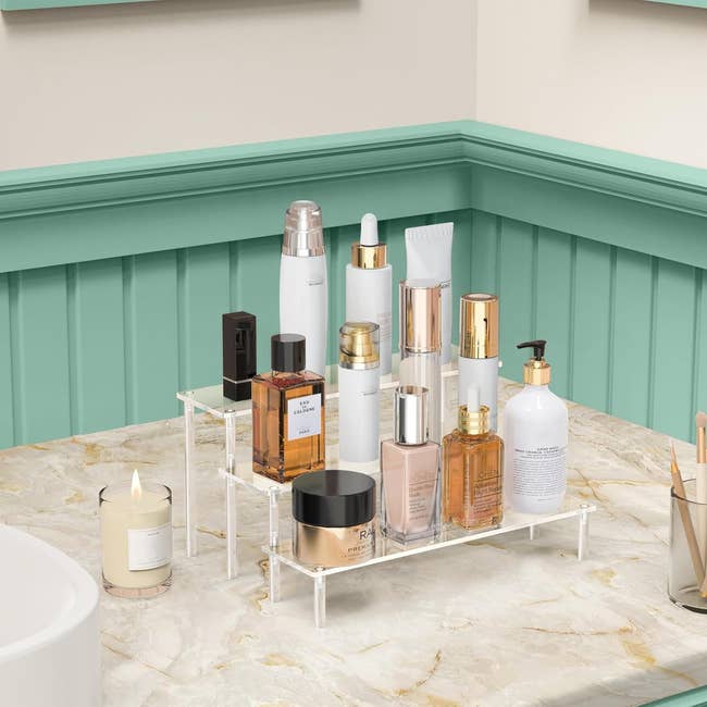 Bathroom antagonistic with a two-tier organizer holding skincare products, serums, and a candle beside a sink, promoting enactment for quality items