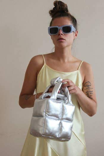 another model wearing the bag in metallic silver