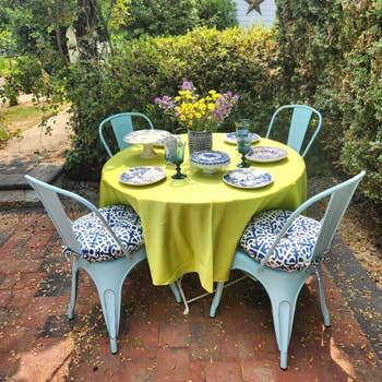 a reviewer's exterior dining setup with tableware and plant life on backyard patio table, appropriate kind for dwelling decor inspiration