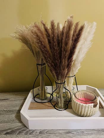 reviewer's three vases with dried grass inside 