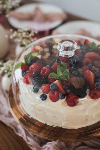 reviewer&rsquo;s cake stand with a berry-topped cake