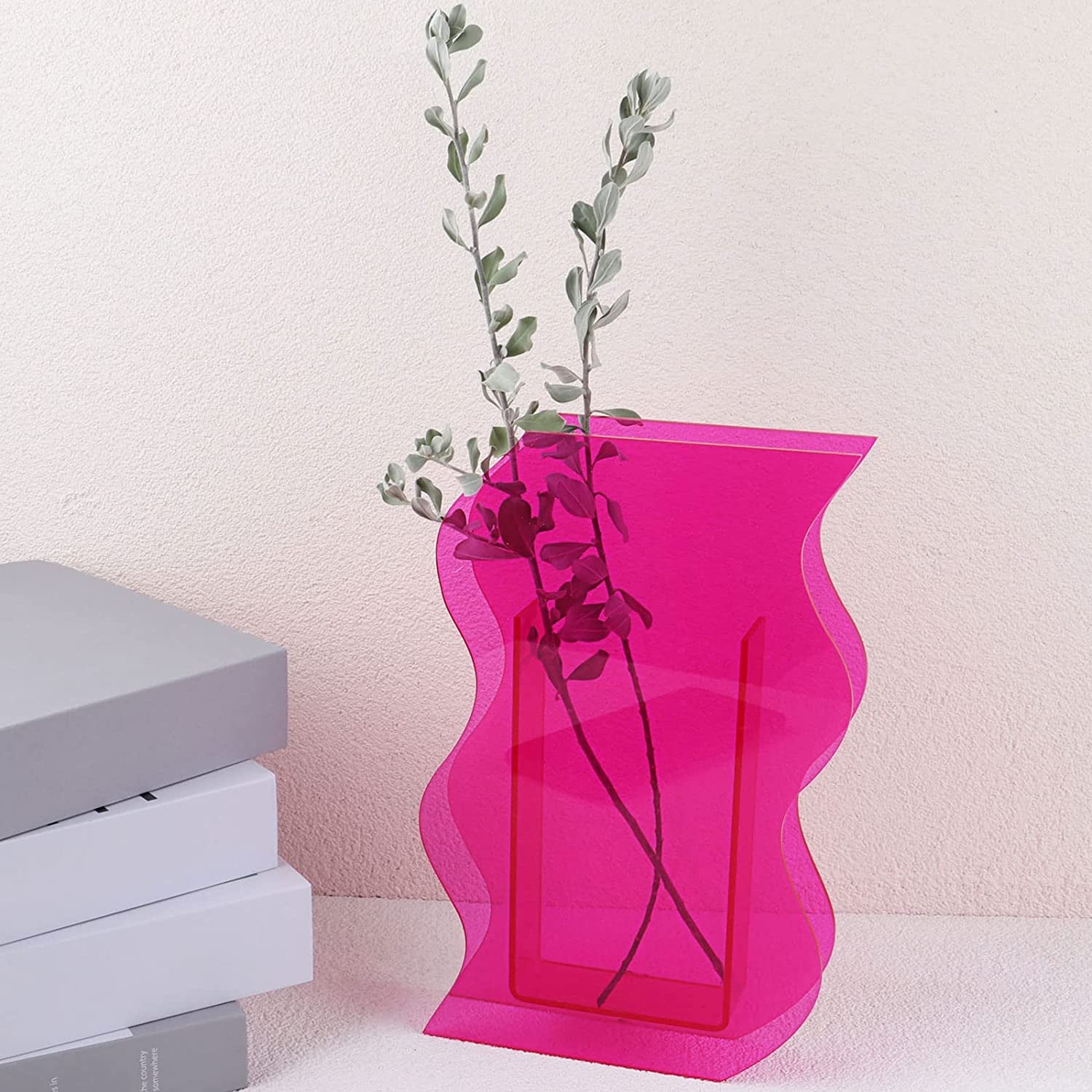 a pink curvy acrylic vase