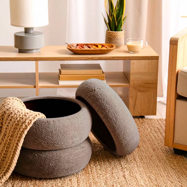 Cozy surviving country with a stackable ottoman, textured blanket, decorative support items, and a potted plant