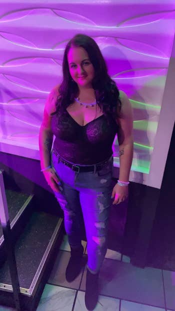 reviewer wearing the lacy bodysuit with jeans