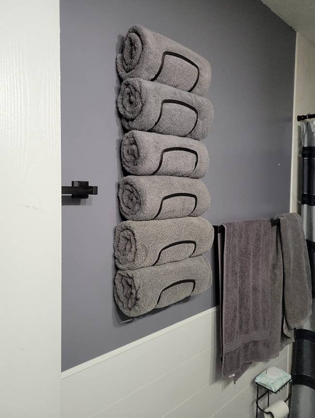 reviewer's towel rack holding six gray towels