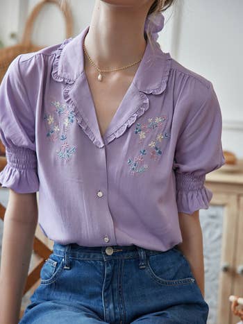 another model wearing the purple floral embroidered blouse