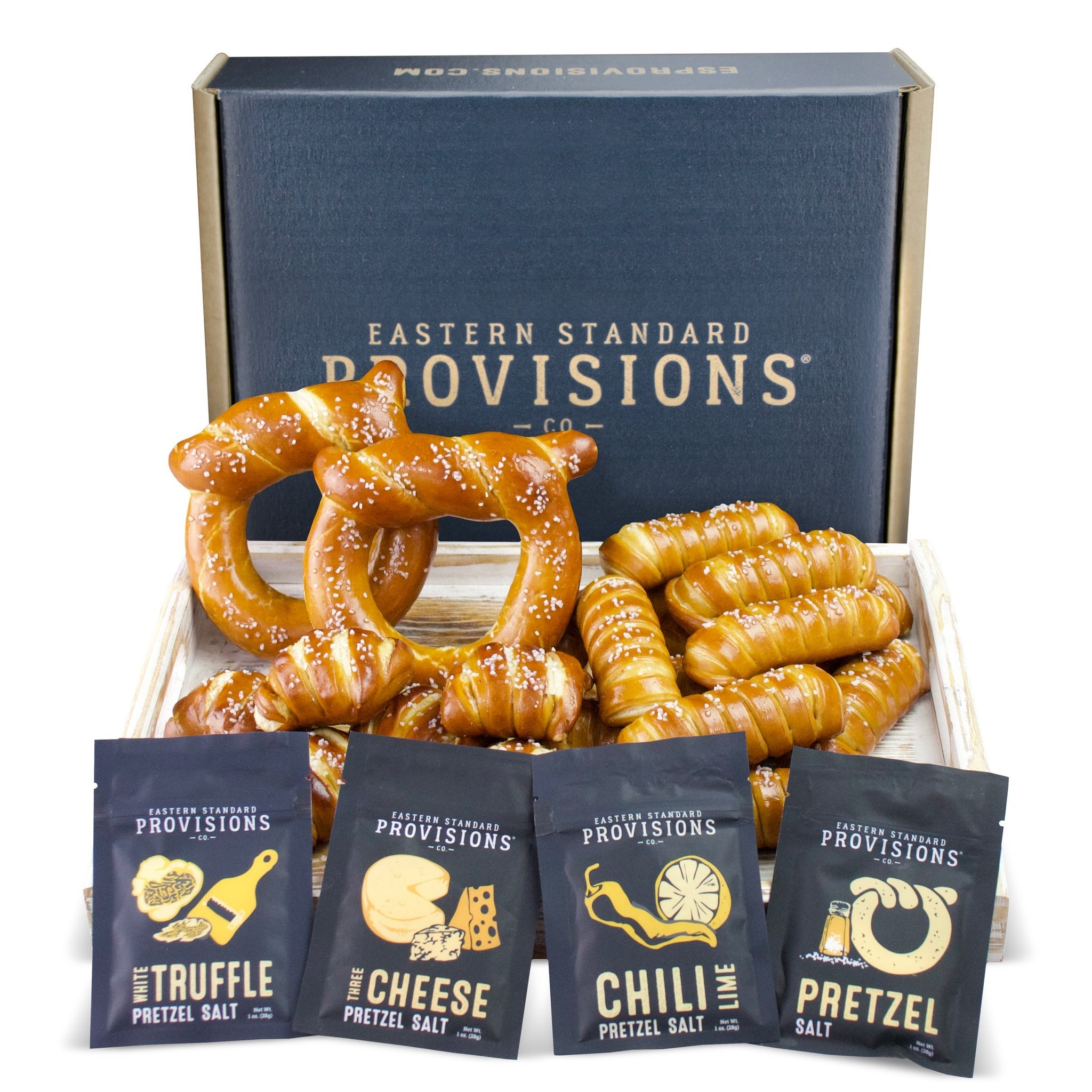 a box of pretzels with different flavored salts in front of them