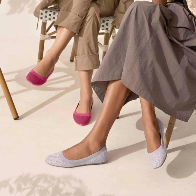 two models wearing the pink and gray flats
